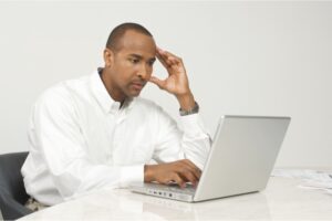 Man Thinking at Computer